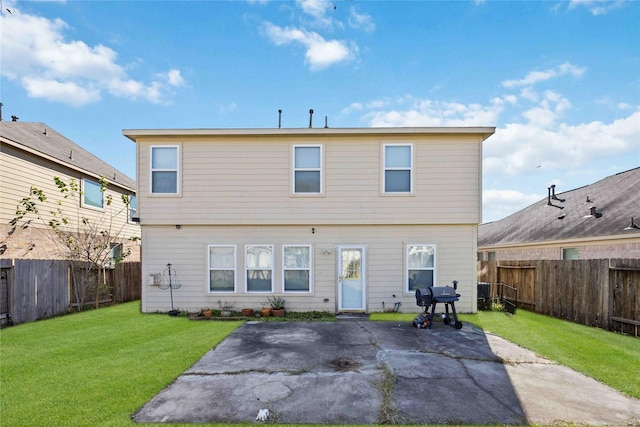 back of property featuring a patio area and a yard