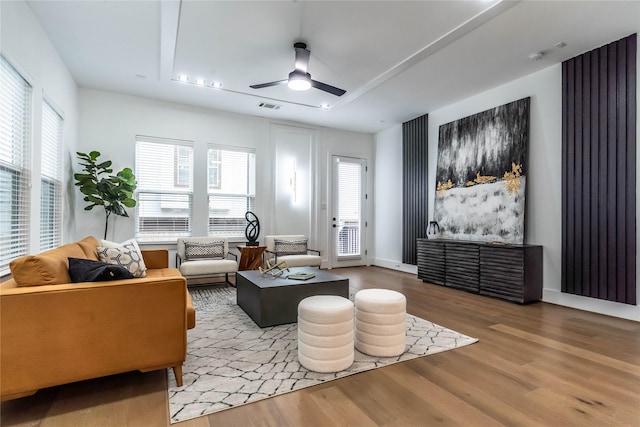 living room featuring hardwood / wood-style floors and ceiling fan