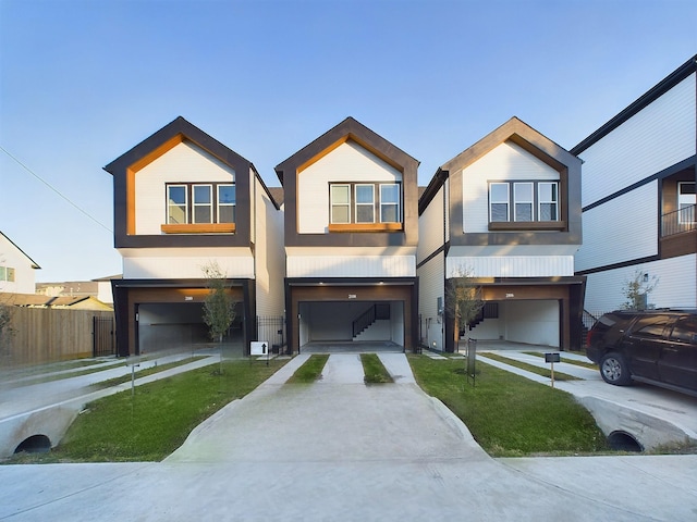 view of front facade featuring a front yard and a garage