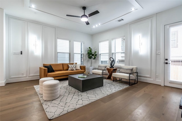 living room featuring ceiling fan and light hardwood / wood-style flooring