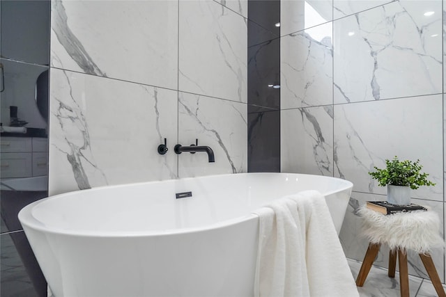 bathroom with a bath and tile walls