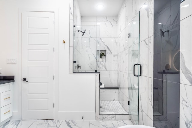 bathroom featuring vanity and a shower with door