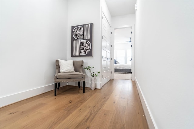 corridor with light hardwood / wood-style floors