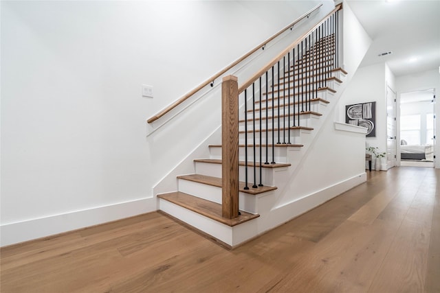 staircase featuring wood-type flooring