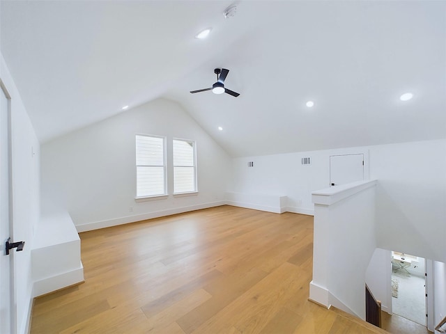 bonus room with ceiling fan, light hardwood / wood-style flooring, and vaulted ceiling