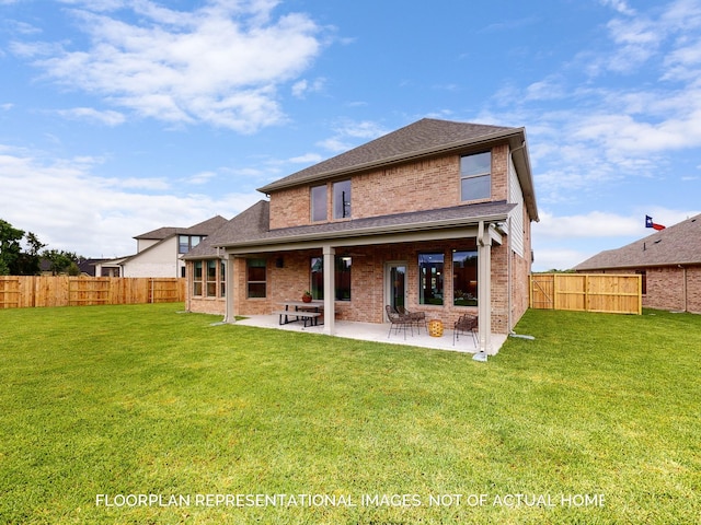 back of house featuring a yard and a patio