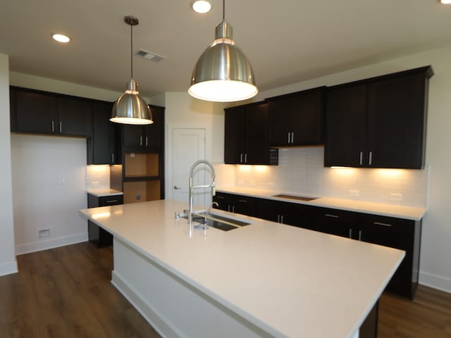 8327 Oceanmist Cove Dr, Cypress, TX 77433 - kitchen with recessed lighting, visible vents, a sink, dark wood-type flooring, and tasteful backsplash