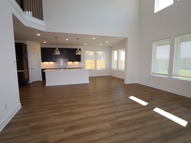 8327 Oceanmist Cove Dr, Cypress, TX 77433 - unfurnished living room with a high ceiling, baseboards, dark wood-type flooring, and recessed lighting