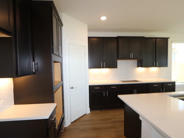 8327 Oceanmist Cove Dr, Cypress, TX 77433 - kitchen featuring recessed lighting, cooktop, wood finished floors, light countertops, and tasteful backsplash