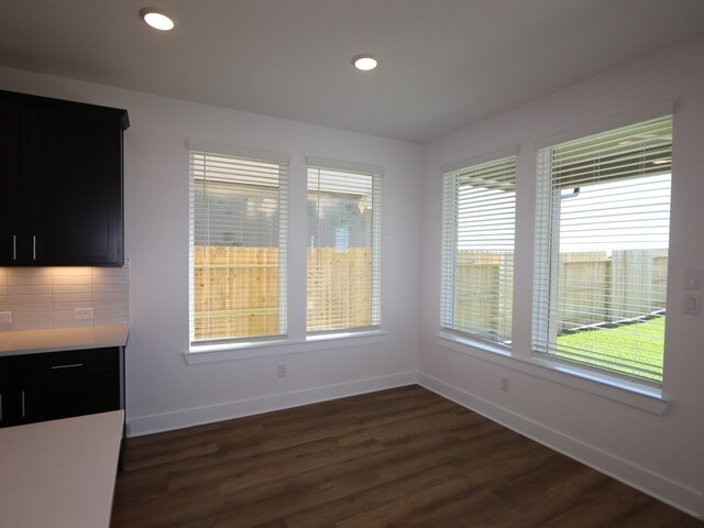 8327 Oceanmist Cove Dr, Cypress, TX 77433 - unfurnished dining area with baseboards, dark wood finished floors, and plenty of natural light