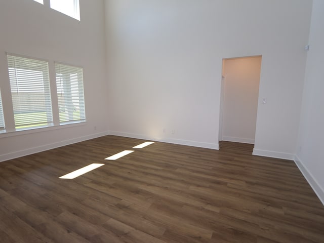 8327 Oceanmist Cove Dr, Cypress, TX 77433 - spare room with baseboards, a high ceiling, and dark wood-style floors