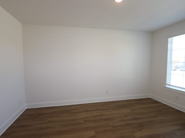 8327 Oceanmist Cove Dr, Cypress, TX 77433 - unfurnished room featuring a wealth of natural light, baseboards, and dark wood-style floors
