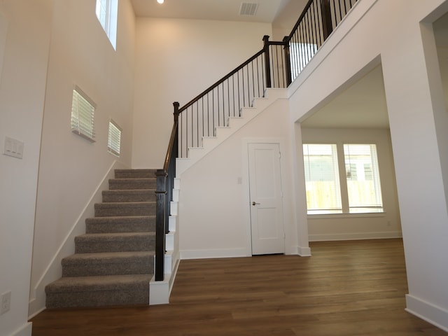 8327 Oceanmist Cove Dr, Cypress, TX 77433 - stairs featuring baseboards, visible vents, a towering ceiling, and wood finished floors