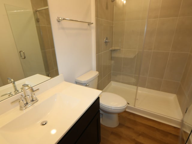 8327 Oceanmist Cove Dr, Cypress, TX 77433 - bathroom with a shower stall, vanity, toilet, and wood finished floors