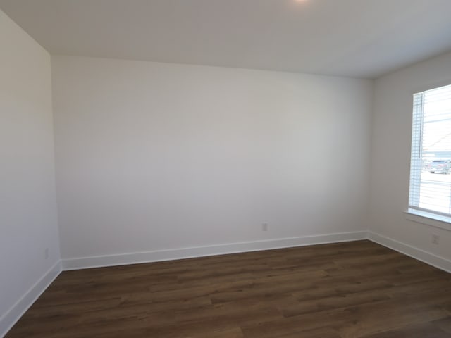 8327 Oceanmist Cove Dr, Cypress, TX 77433 - spare room featuring baseboards, a wealth of natural light, and dark wood-style flooring