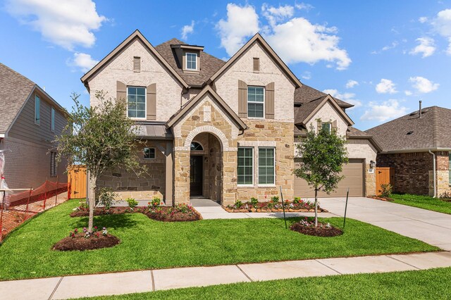 8327 Oceanmist Cove Dr, Cypress, TX 77433 - french country home with stone siding, concrete driveway, a garage, and brick siding