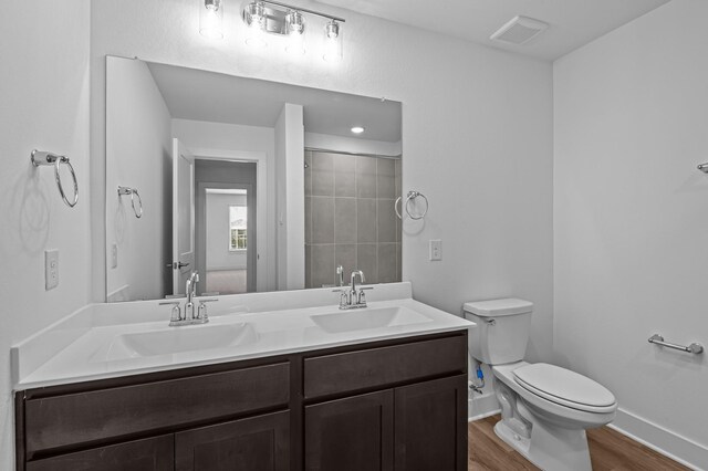 8327 Oceanmist Cove Dr, Cypress, TX 77433 - full bath featuring double vanity, toilet, wood finished floors, a shower, and baseboards