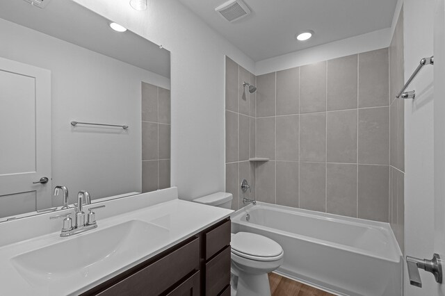8327 Oceanmist Cove Dr, Cypress, TX 77433 - bathroom with toilet, vanity, bathing tub / shower combination, wood finished floors, and recessed lighting