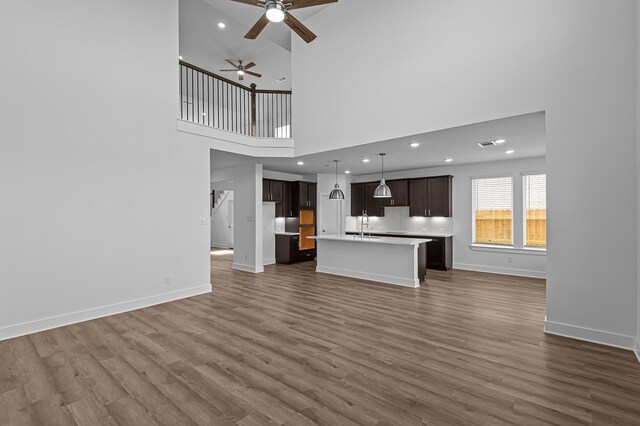 8327 Oceanmist Cove Dr, Cypress, TX 77433 - unfurnished living room with ceiling fan, dark wood-style flooring, recessed lighting, a sink, and baseboards