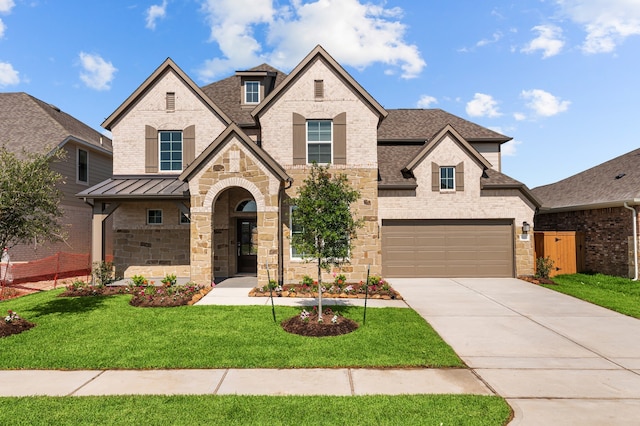 8327 Oceanmist Cove Dr, Cypress, TX 77433 - french country style house with driveway, a shingled roof, brick siding, stone siding, and a standing seam roof
