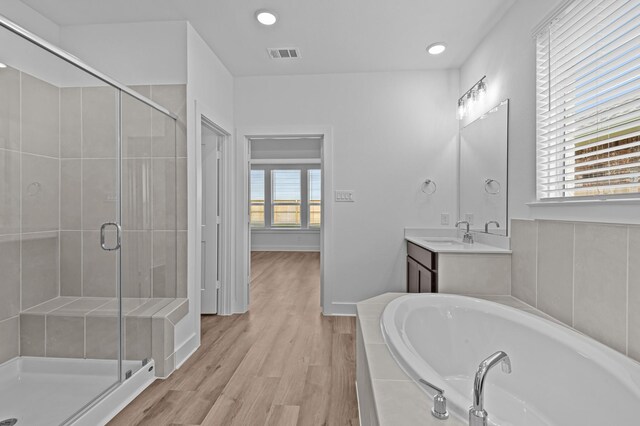 8327 Oceanmist Cove Dr, Cypress, TX 77433 - full bath with a bath, a shower stall, vanity, wood finished floors, and recessed lighting