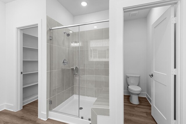 8327 Oceanmist Cove Dr, Cypress, TX 77433 - bathroom with a stall shower, toilet, wood finished floors, baseboards, and recessed lighting
