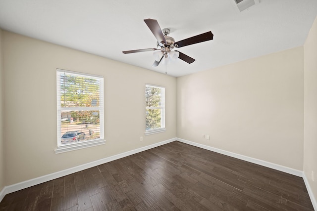 empty room featuring ceiling fan and dark hardwood / wood-style flooring