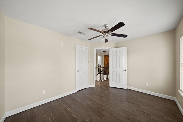 spare room featuring ceiling fan and dark hardwood / wood-style floors