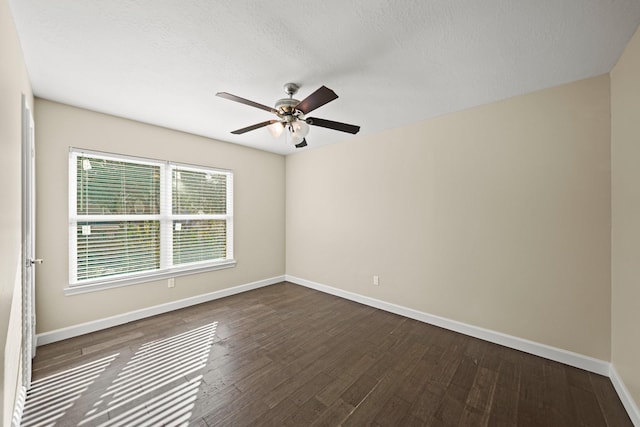 spare room featuring dark hardwood / wood-style floors, ceiling fan, and a textured ceiling