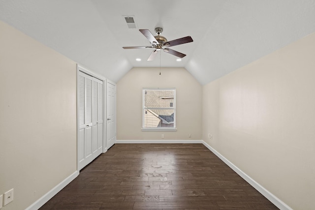 additional living space with dark hardwood / wood-style flooring, vaulted ceiling, and ceiling fan