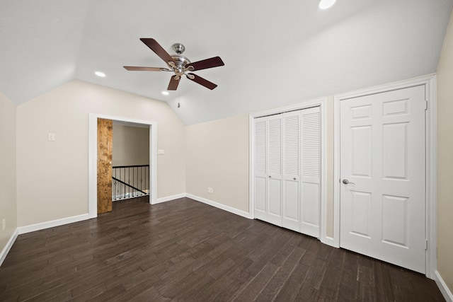 unfurnished bedroom featuring dark hardwood / wood-style floors, ceiling fan, and vaulted ceiling