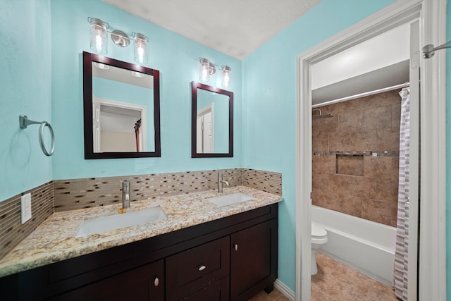 full bathroom featuring tile patterned floors, vanity, toilet, and shower / tub combo