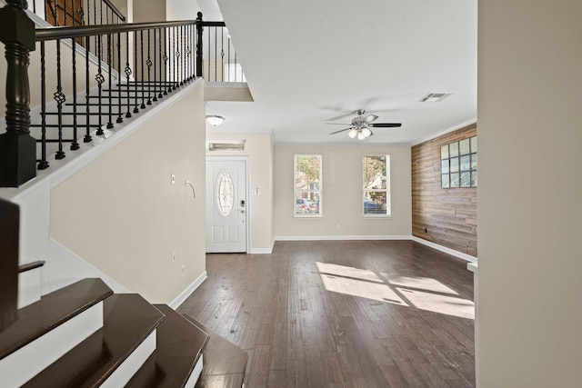 entrance foyer with wooden walls, dark hardwood / wood-style flooring, and ceiling fan