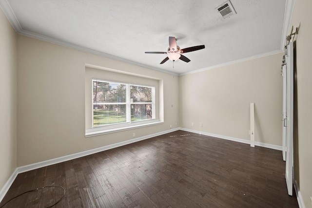 empty room with a textured ceiling, dark hardwood / wood-style floors, ceiling fan, and ornamental molding