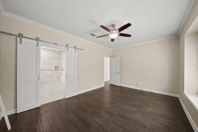 interior space with a barn door, crown molding, ceiling fan, and dark hardwood / wood-style floors