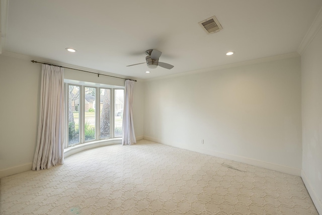 spare room featuring ceiling fan, ornamental molding, and light carpet