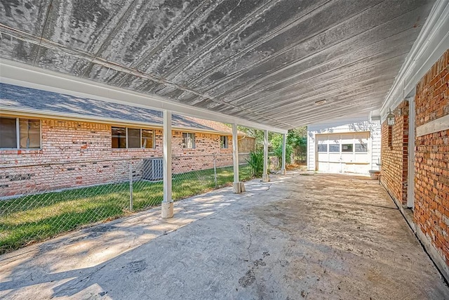 view of patio / terrace with a garage and central air condition unit