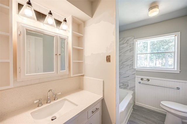 bathroom featuring toilet, vanity, and hardwood / wood-style flooring