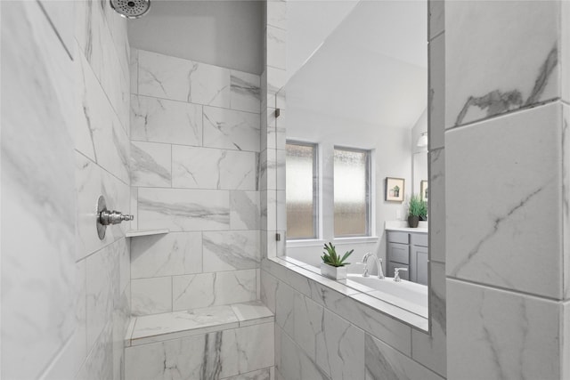 bathroom with vanity and tiled shower