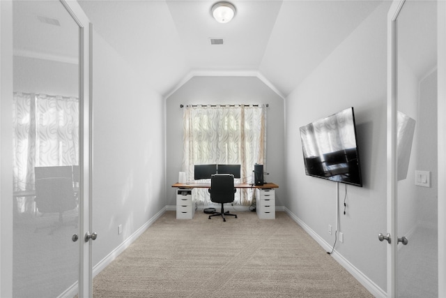 office space with light colored carpet and vaulted ceiling