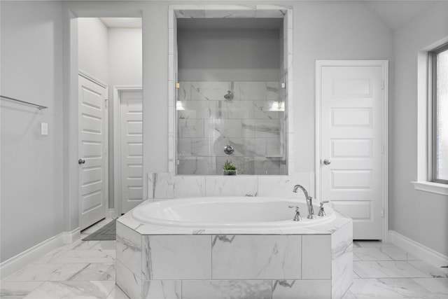 bathroom featuring separate shower and tub