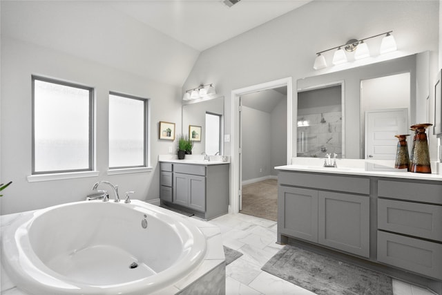 bathroom featuring vanity, shower with separate bathtub, and vaulted ceiling