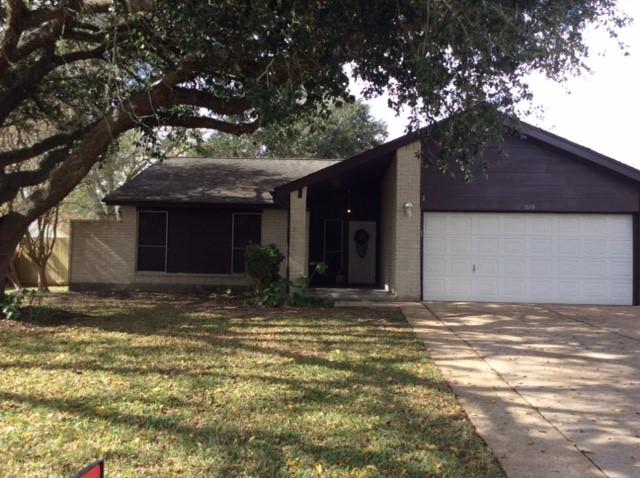 ranch-style house with a front yard and a garage