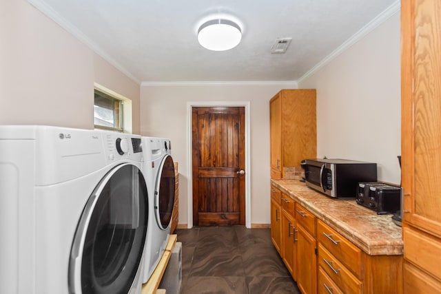 washroom with washer and dryer and crown molding