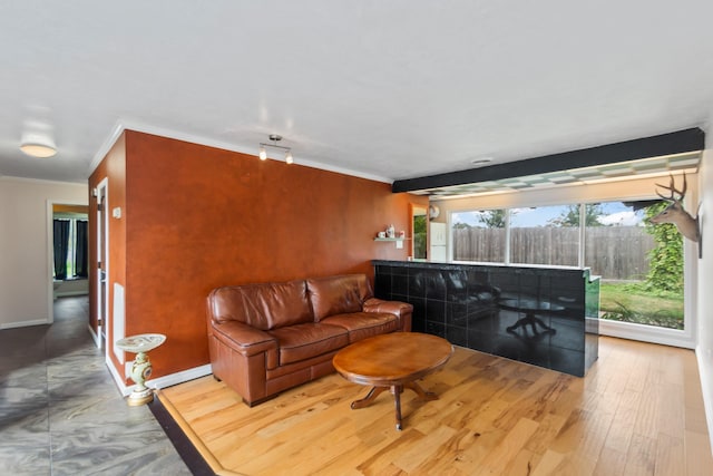 living room featuring beamed ceiling, wood-type flooring, and crown molding