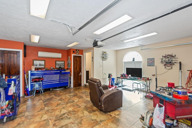 living room featuring a wall mounted air conditioner and a textured ceiling