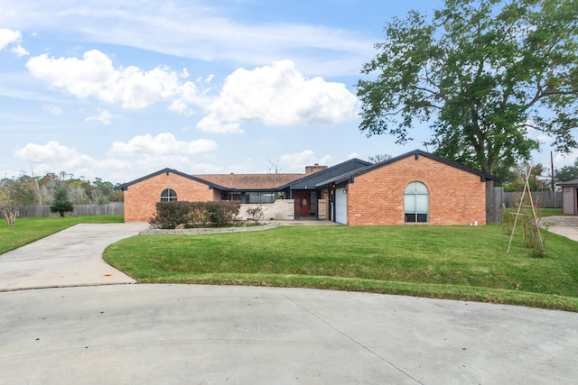 single story home featuring a front yard and a garage