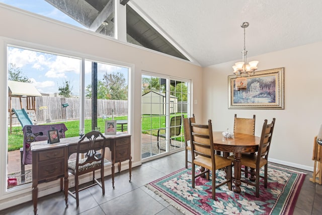 dining area with a chandelier, a textured ceiling, vaulted ceiling, and a healthy amount of sunlight