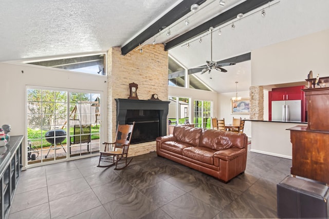 living room featuring high vaulted ceiling, a healthy amount of sunlight, and a textured ceiling