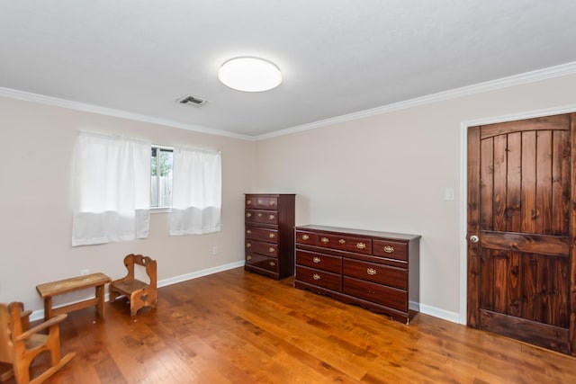 interior space featuring crown molding and hardwood / wood-style flooring